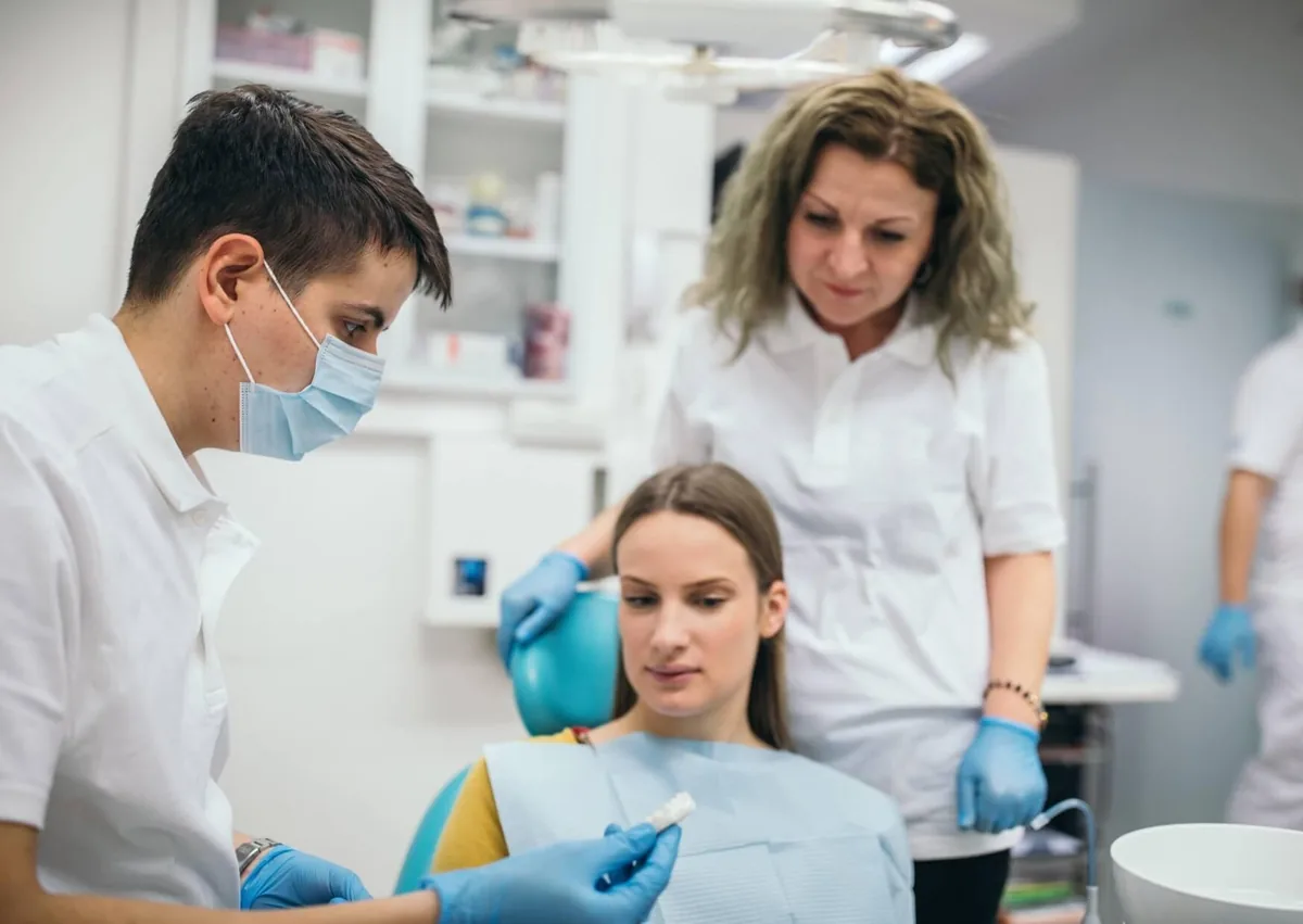 Dental team discussing affordable dental implant treatment options with a patient during a consultation.