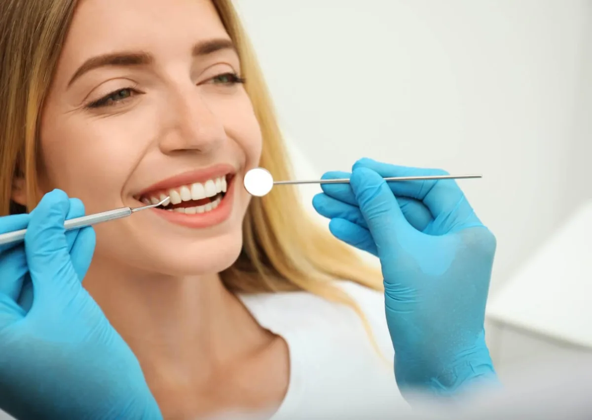 Dentist examining a patient’s smile during a cosmetic dentistry evaluation.