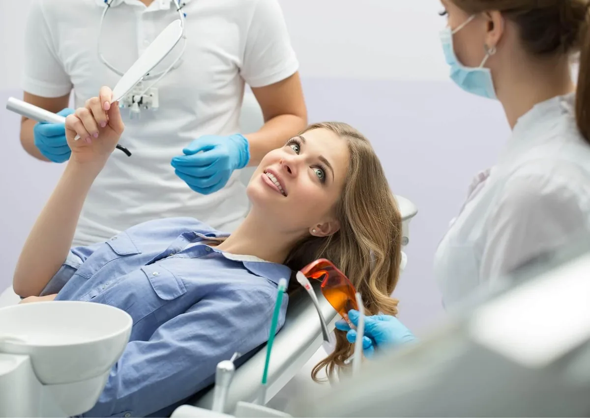 Patient reviewing her smile with a dental team during a cosmetic dentistry consultation.