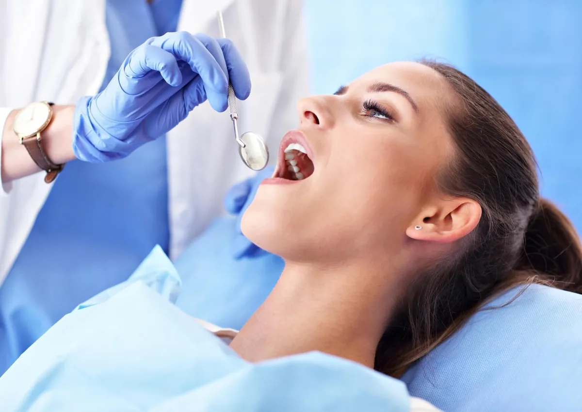Dentist examining a patient’s tooth during an evaluation for root canal treatment and cost.