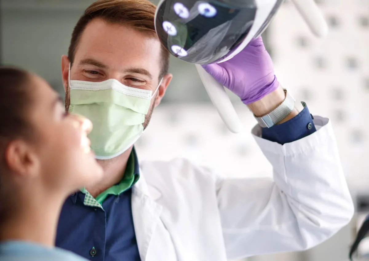 Patient receiving a dental examination as part of planning a personalized smile makeover.